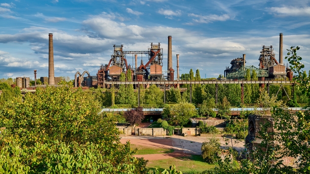 Steel plant in the middle of a green landscape.